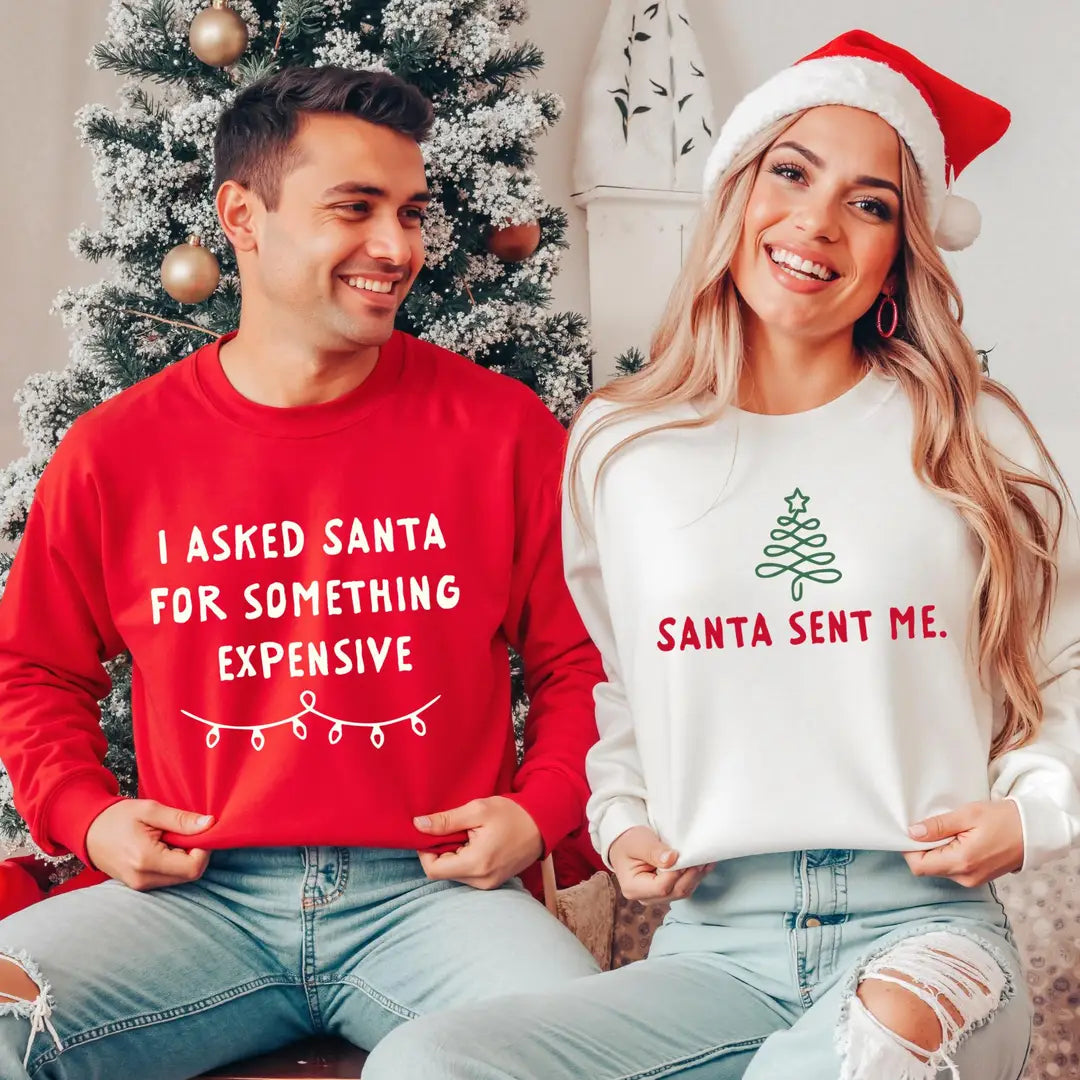 Christmas couple sweatshirts: red 'I Asked Santa' and white 'Santa Sent Me' designs.