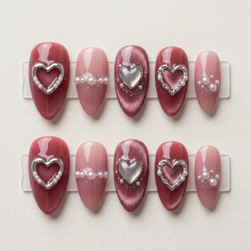 mauve cat eye almond press on nails 3d silver heart pearl flat lay 01