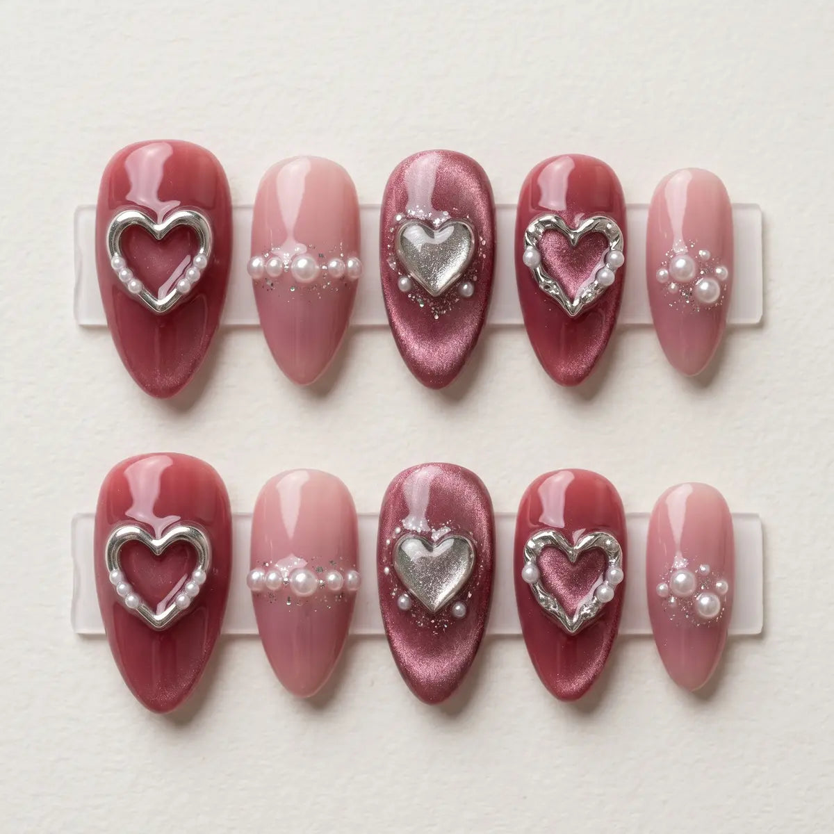 mauve cat eye almond press on nails 3d silver heart pearl flat lay 01