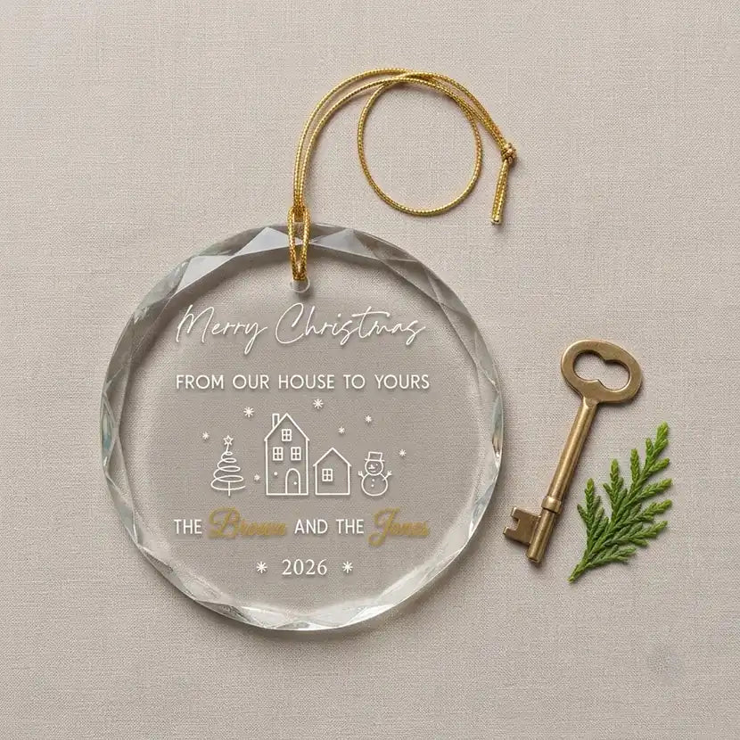 Clear glass round ornament laid flat on festive wooden surface with pine branches, pinecones and holiday decorations surrounding the neighbor holiday design