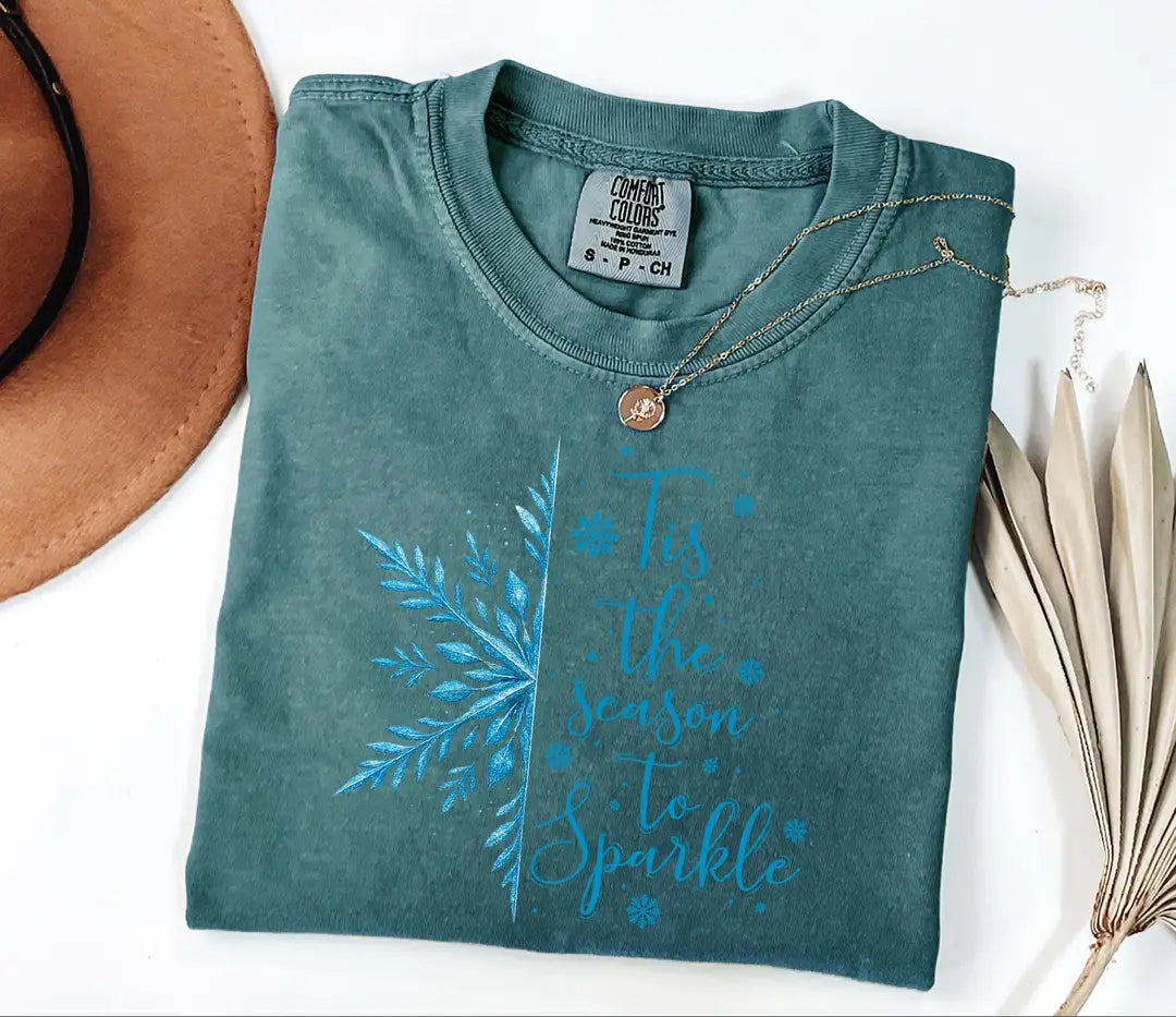 Blue Spruce Comfort Colors T-shirt with blue winter greenery and 'Tis the Season to Sparkle' artwork.