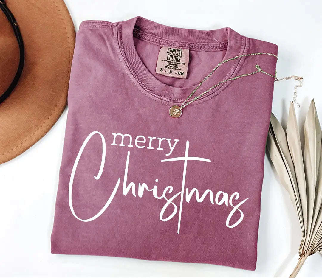 Merry Christmas lettering on a muted purple Comfort Colors T-shirt mockup.