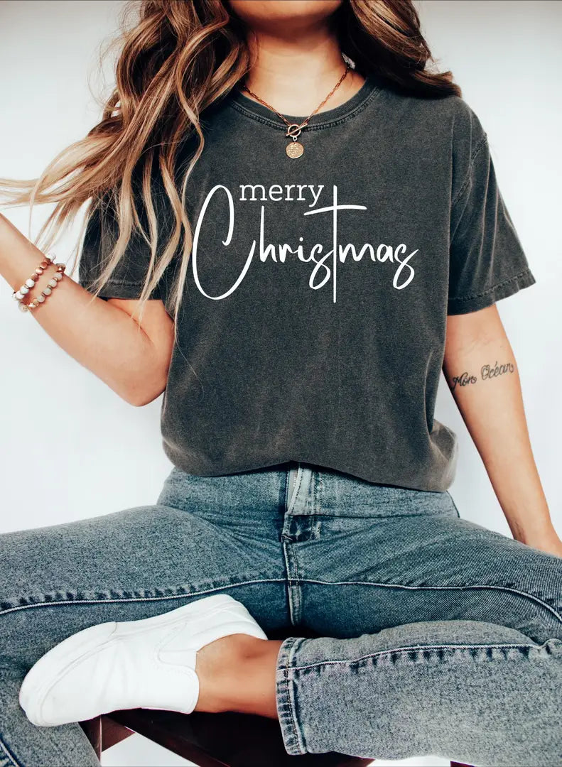 Merry Christmas lettering modeled on a charcoal Pepper Comfort Colors T-shirt.