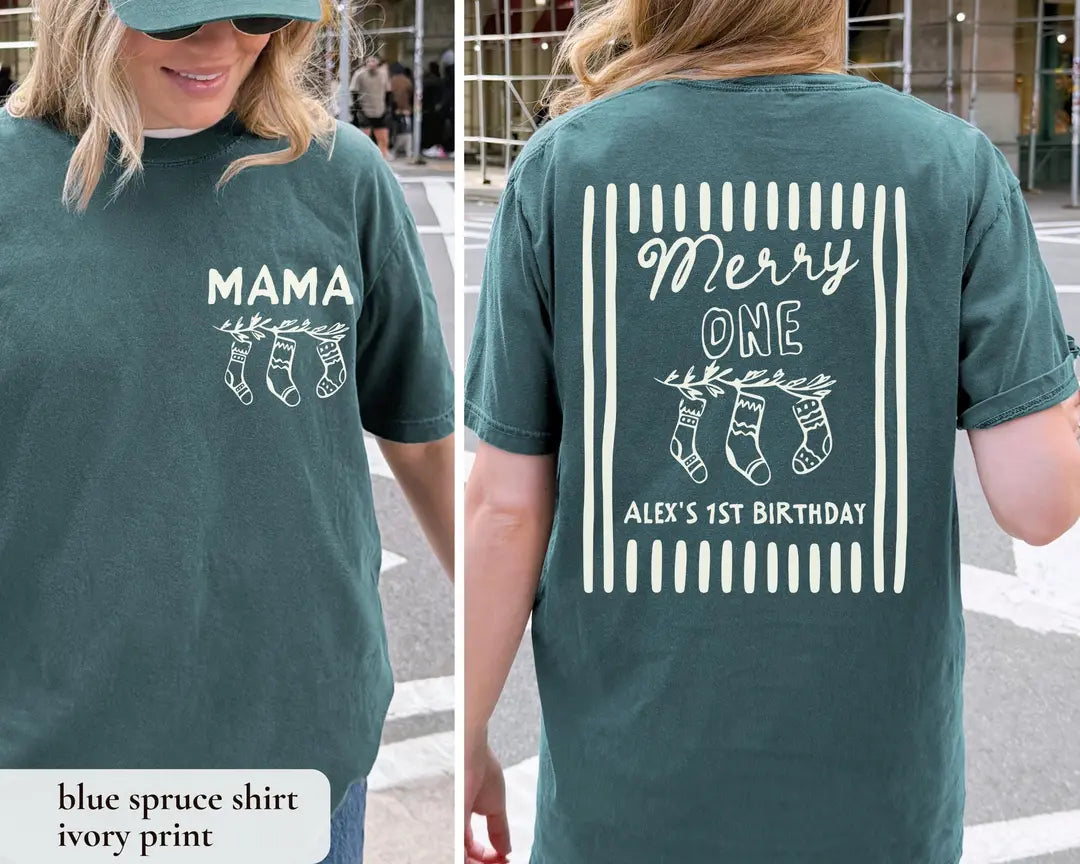 Woman in a Blue Spruce Comfort Colors tee, front with an ivory MAMA print and back with Merry ONE stockings