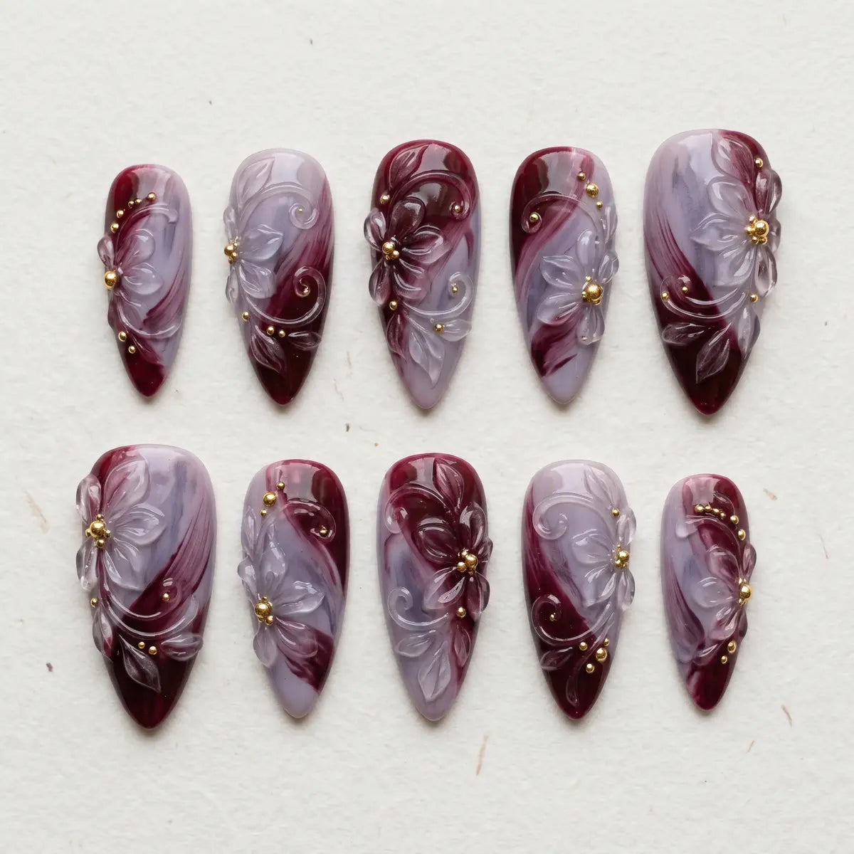 midnight plum 3d almond long press on nails lily gold bead flat lay 01