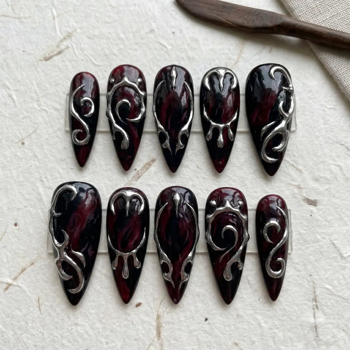 midnight plum 3d stiletto long press on nails silver scroll flat lay 01
