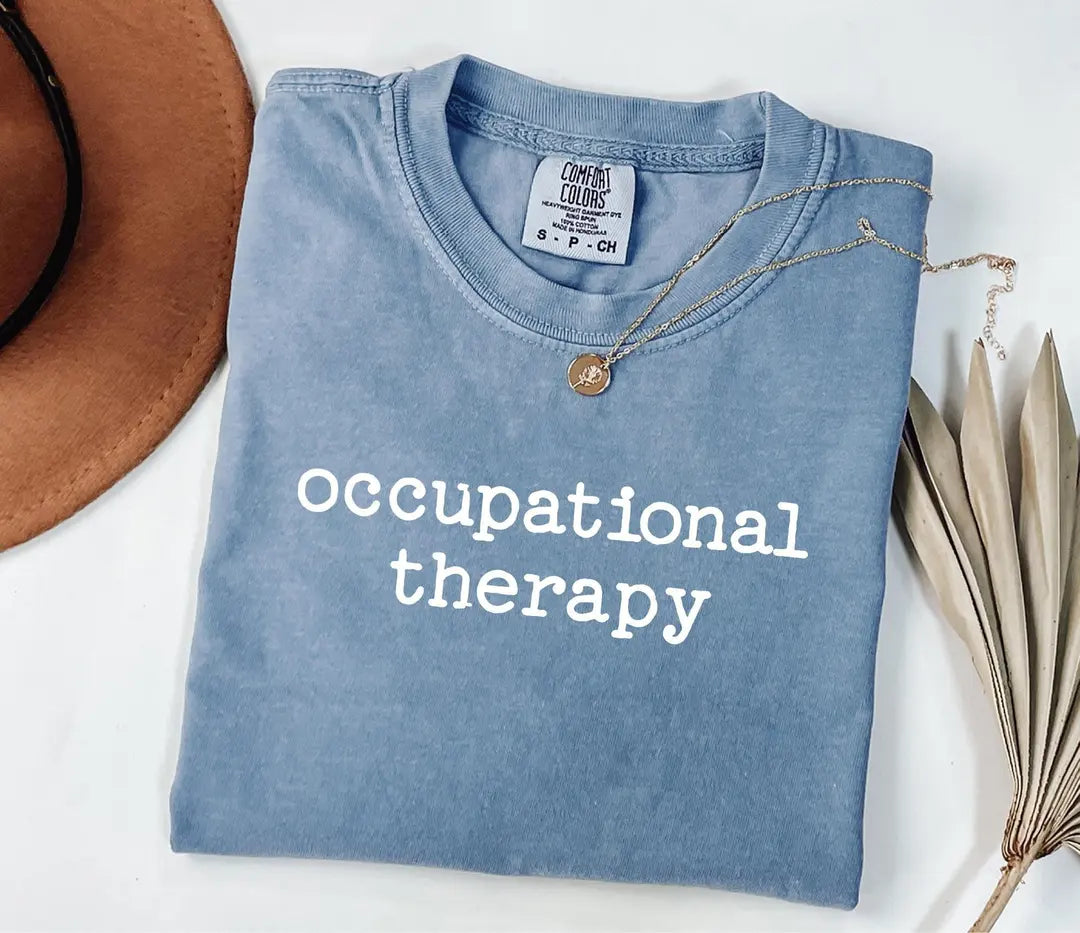 Blue Jean Comfort Colors 1717 tee with lowercase 'occupational therapy' in white lettering.