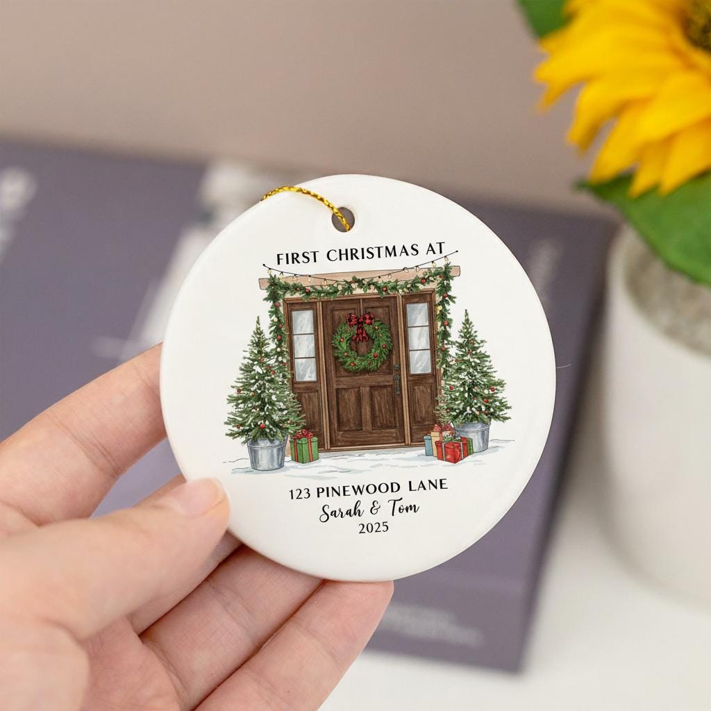 Personalized Christmas ornament with a house illustration and text, held by a hand.
