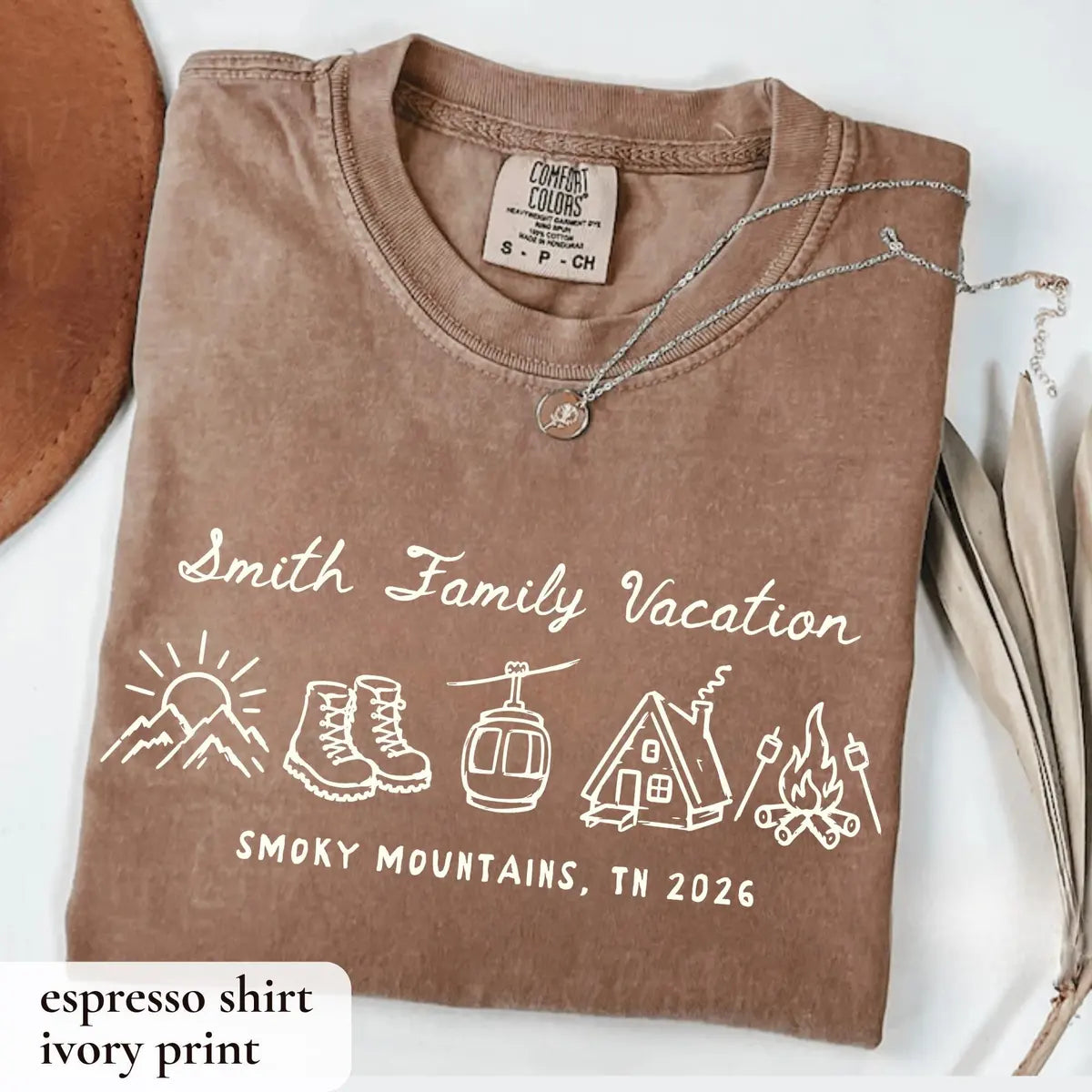 Folded Espresso brown Comfort Colors tee with ivory Smith Family Vacation script, sunrise, boots, gondola and campfire