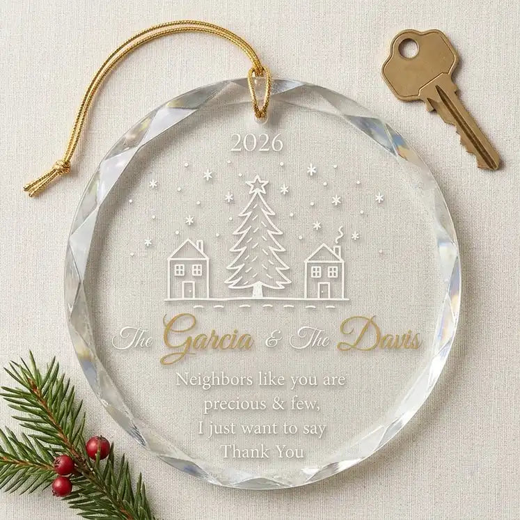 Clear glass round ornament laid flat on festive wooden surface with pine branches, pinecones and holiday decorations surrounding the neighbor gift design