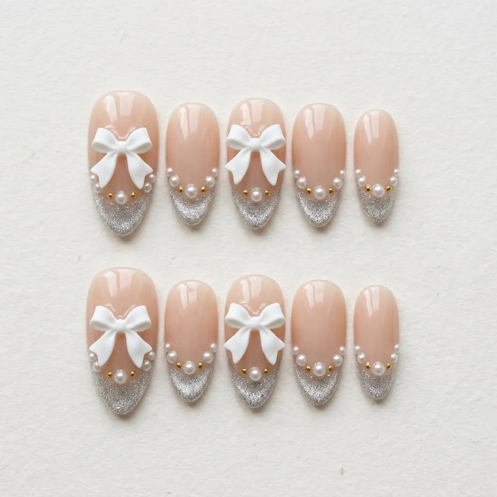 nude 3d french tip almond press on nails ribbon bow pearl flat lay 01