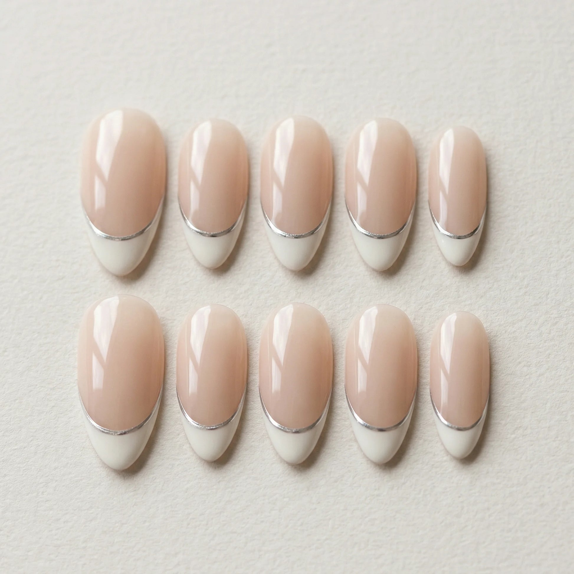 nude french tip hand painted almond medium press on nails silver lining flat lay 01