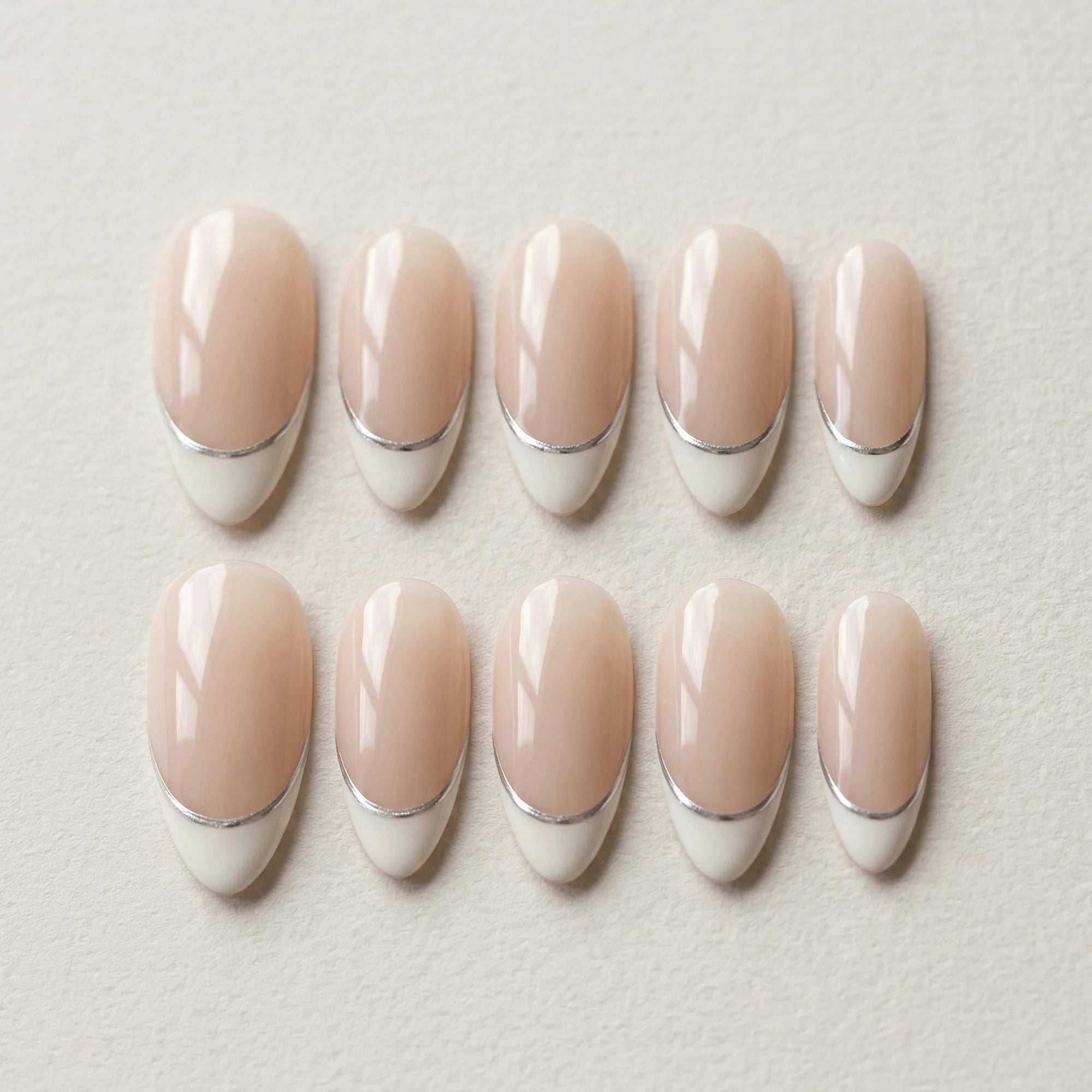 nude french tip hand painted almond medium press on nails silver lining flat lay 01