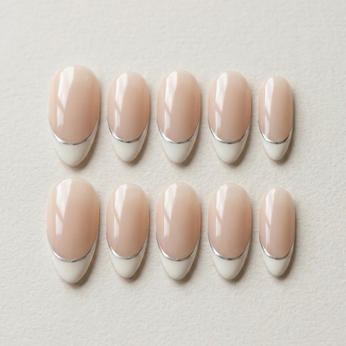 nude french tip hand painted almond medium press on nails silver lining flat lay 01