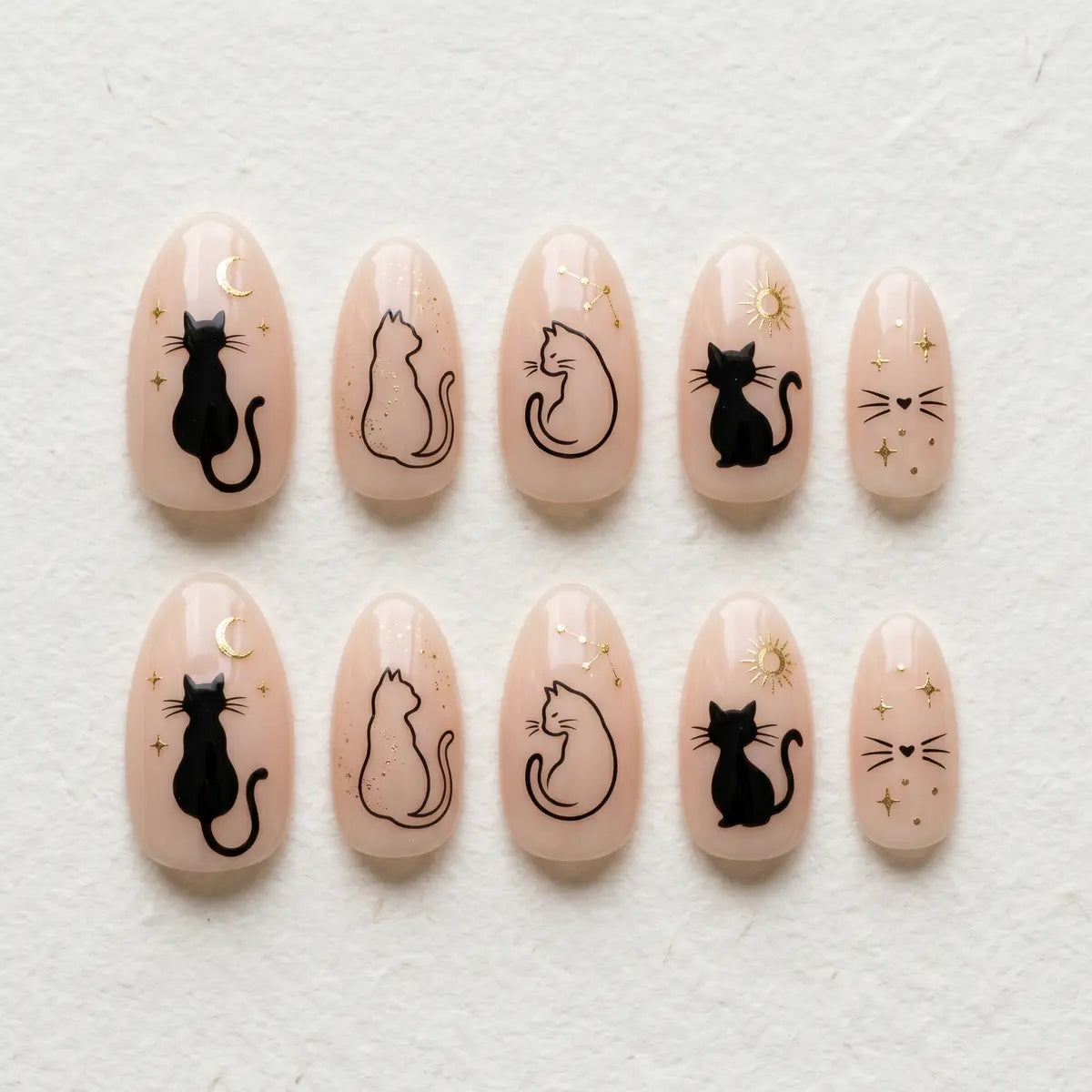 nude hand painted almond press on nails black cat moon star flat lay 01