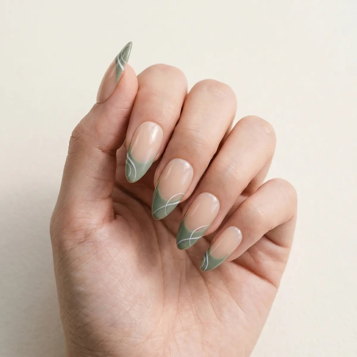 nude sage green french tip almond long press on nails white swirl flat lay 01