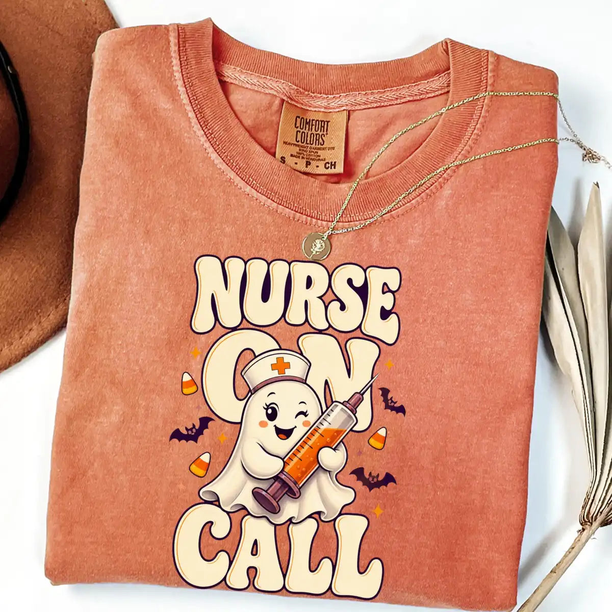 Comfort Colors T-shirt flatlay in Terracotta color featuring Nurse On Call syringe ghost graphic