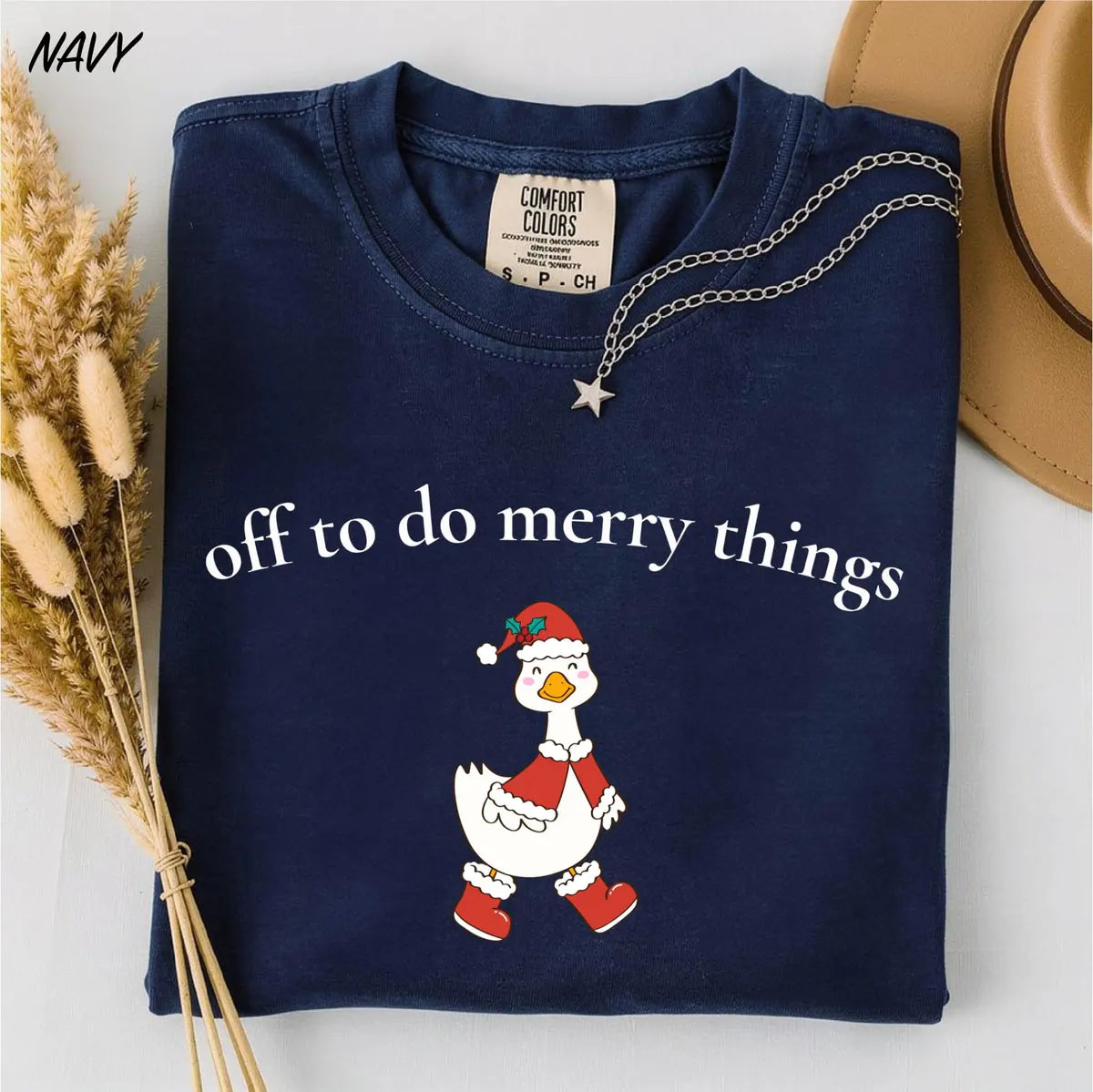 Comfort Colors T-shirt with Off To Do Merry Things holiday design; model photo.