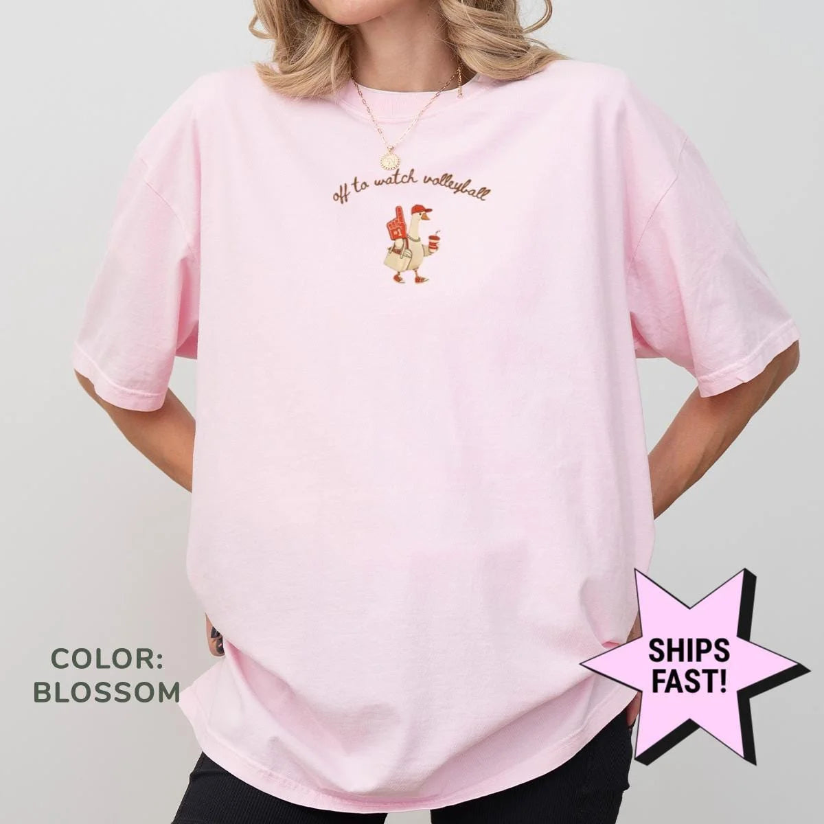 Blossom pink Comfort Colors tee with a small goose and Off to Watch Volleyball print, front view on a model