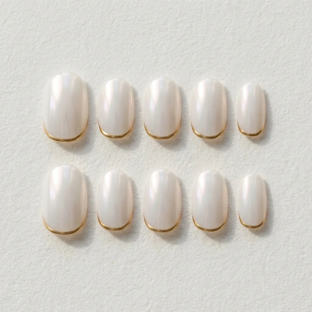 pearl white oval press on nails gold tip flat lay 01