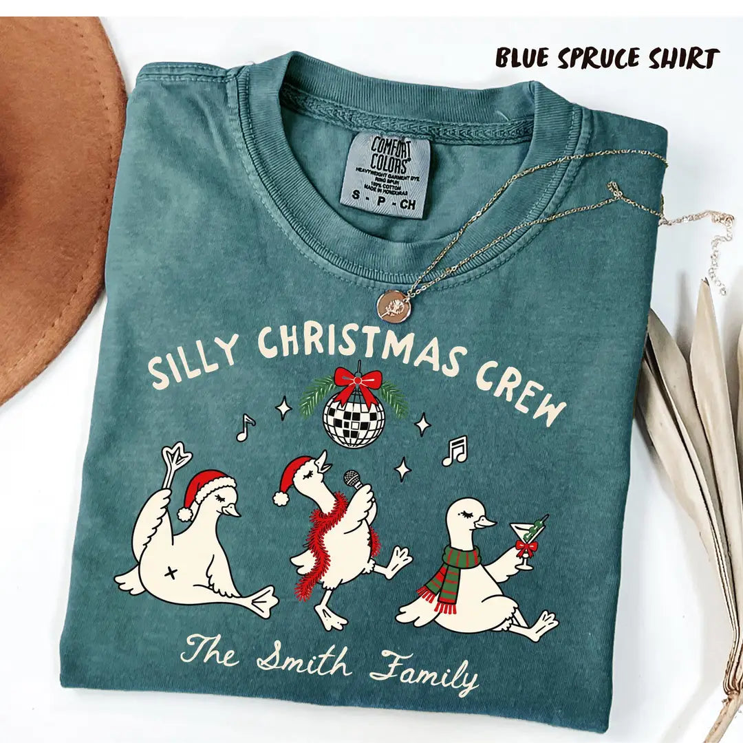 Silly Christmas Crew personalized family name and geese design on Blue Spruce Comfort Colors 1717 T-shirt.