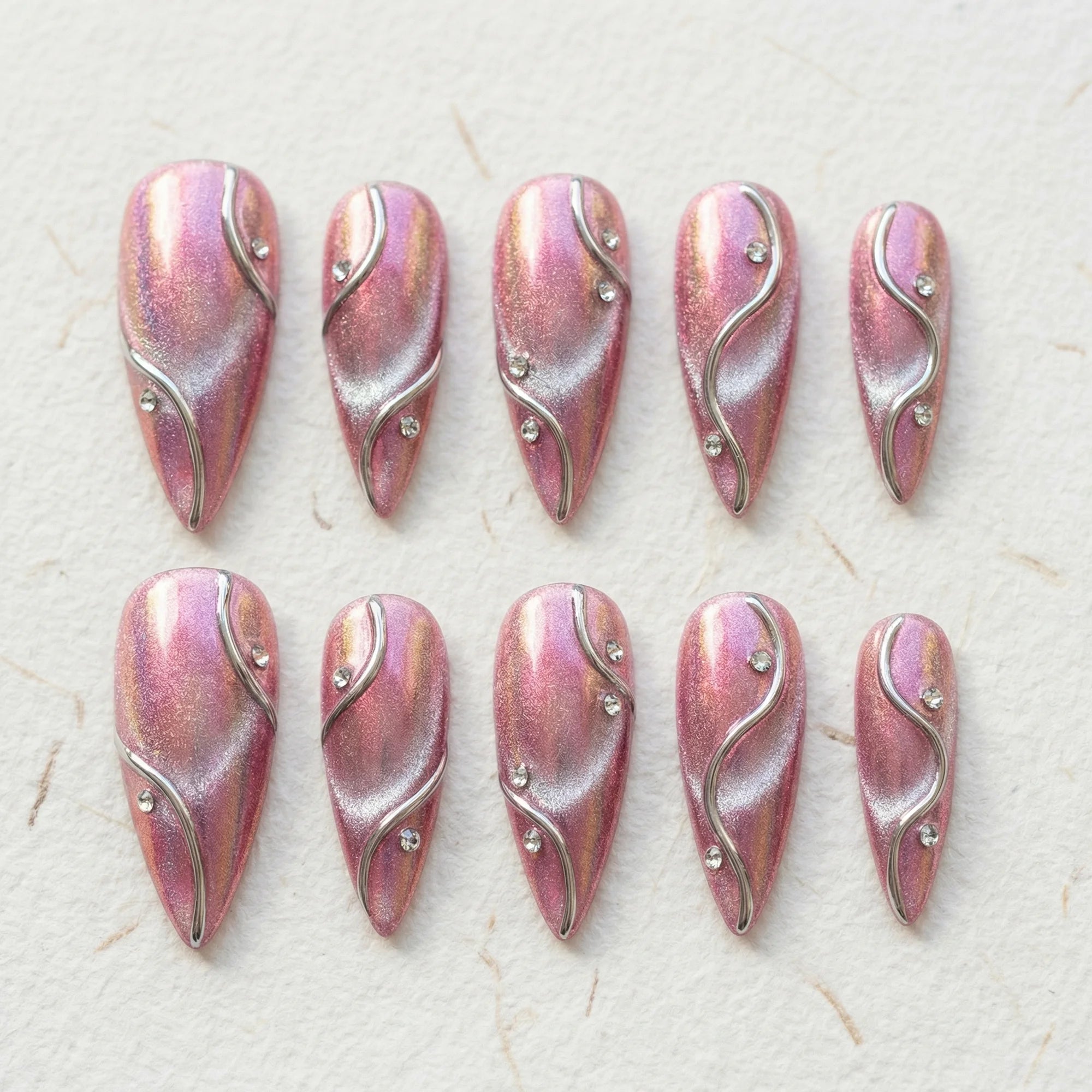 pink chrome stiletto medium press on nails silver wavy line flat lay 01