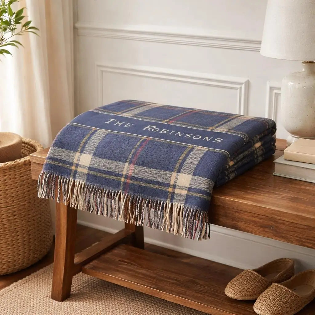 Personalized plaid banner woven blanket shown in a styled room setting