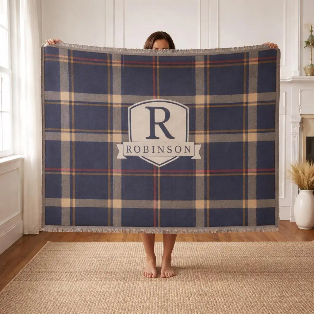 Personalized plaid crest woven blanket shown in a styled room setting