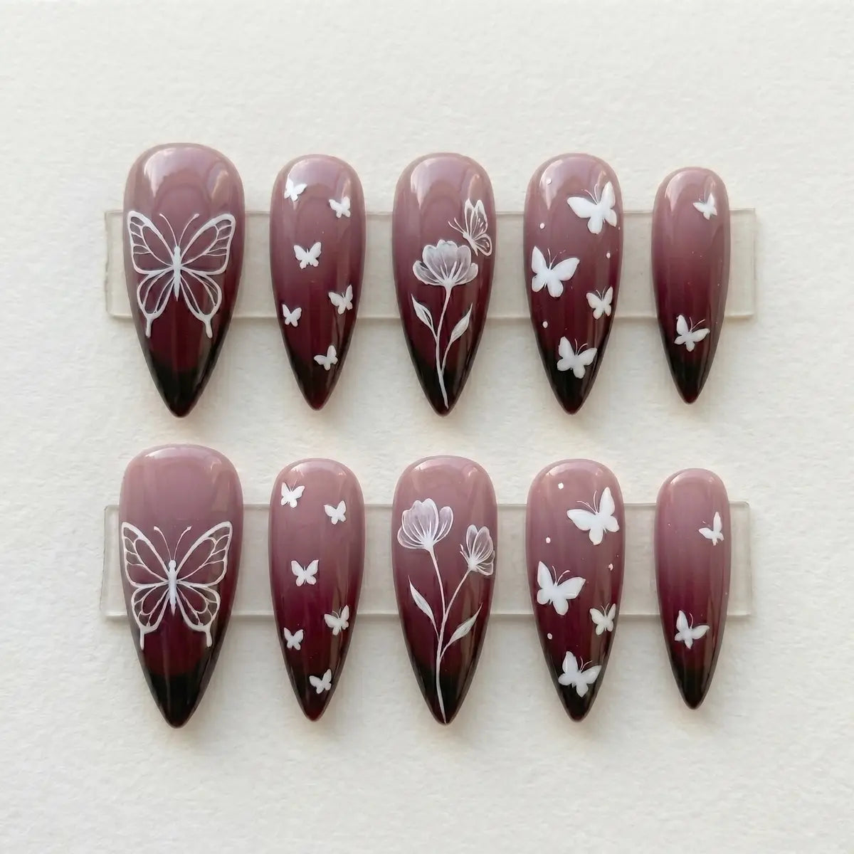 plum ombre hand painted stiletto long press on nails butterfly floral flat lay 01