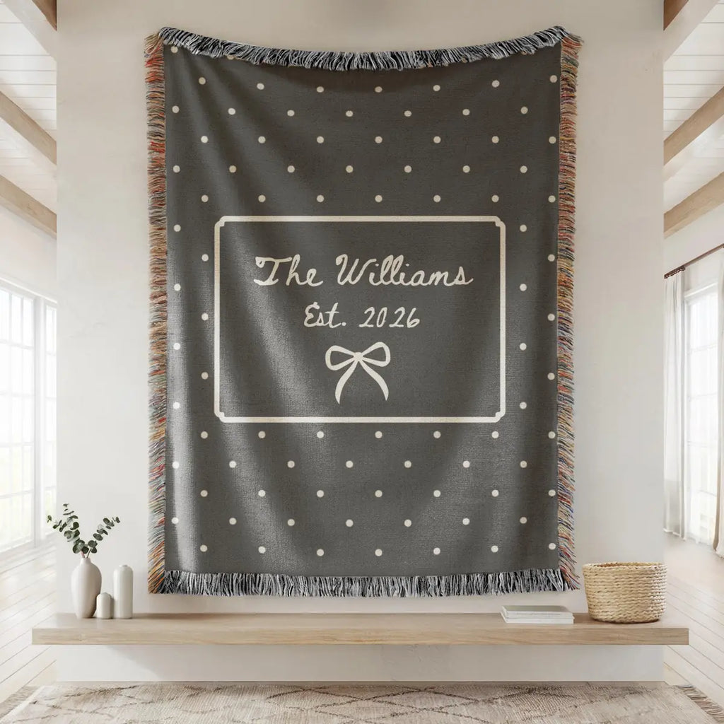 Close-up of the personalized polka dot bow woven blanket with texture and fringe detail