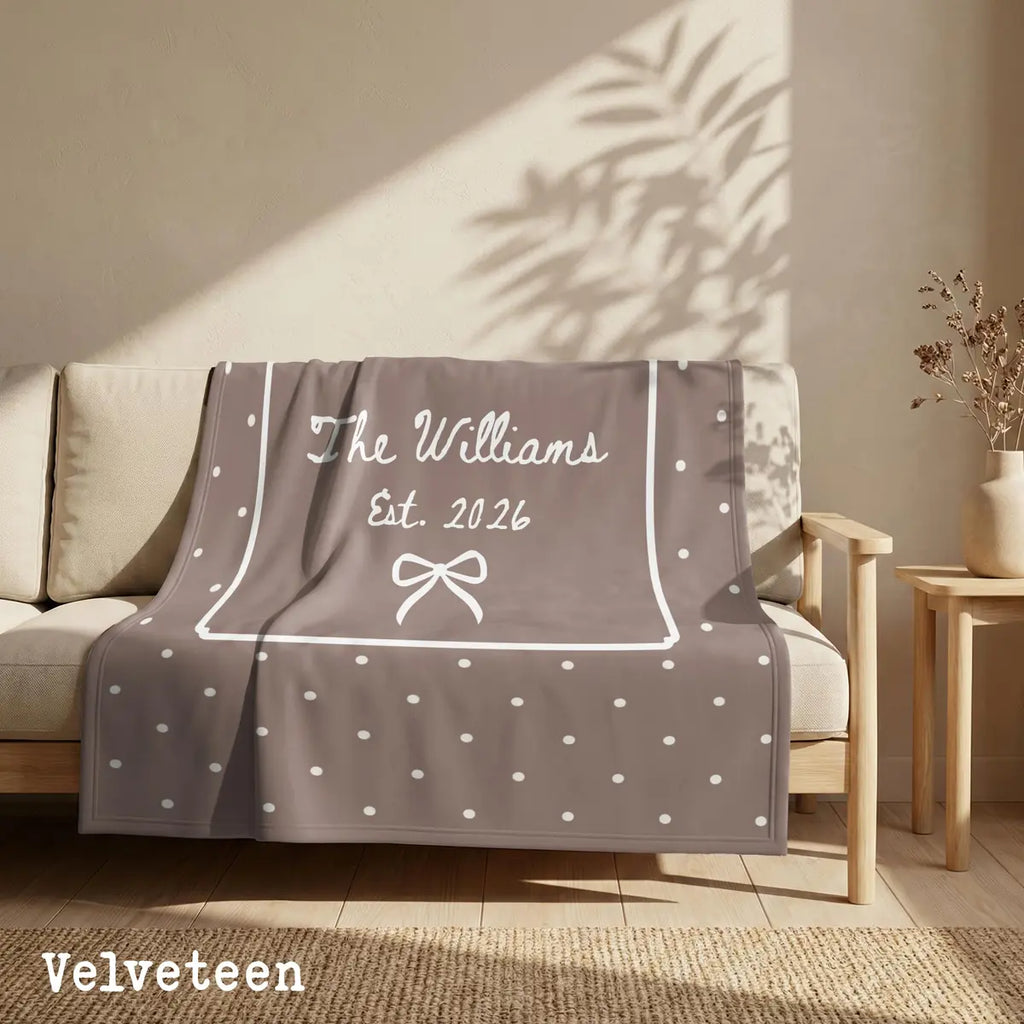 Close-up of the personalized polka dot bow woven blanket with texture and fringe detail