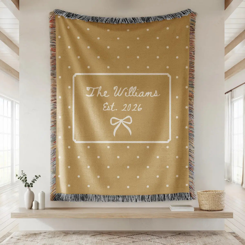 Close-up of the personalized polka dot bow woven blanket with texture and fringe detail