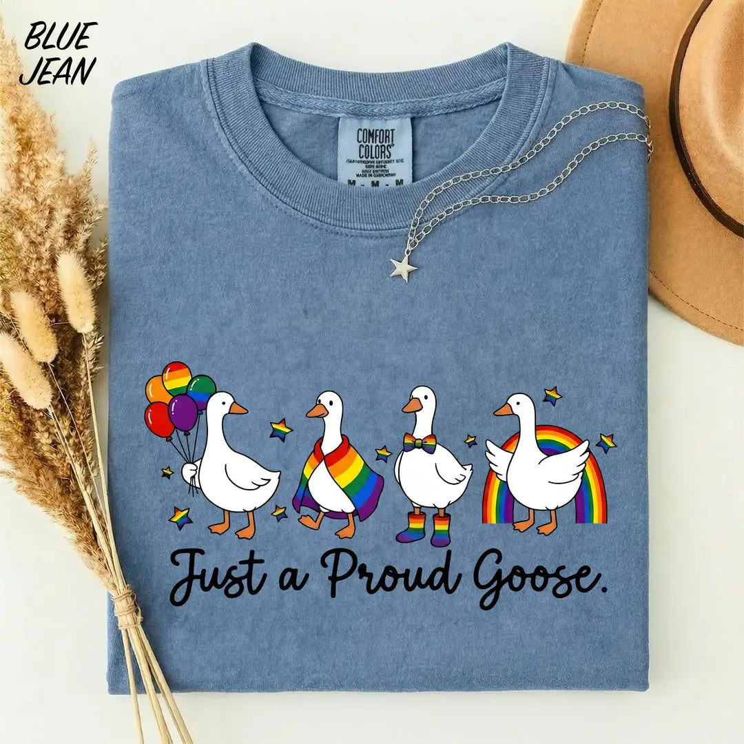 Blue Jean Comfort Colors 1717 T-shirt with rainbow-themed geese and Just a Proud Goose lettering.
