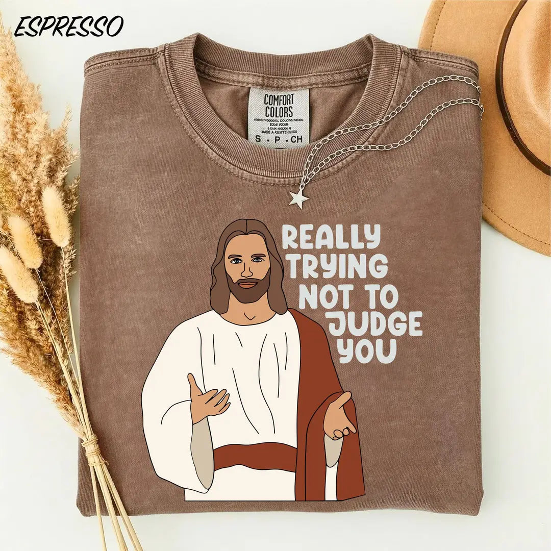 Espresso Comfort Colors 1717 tee with illustrated Jesus and 'Really trying not to judge you' wording.