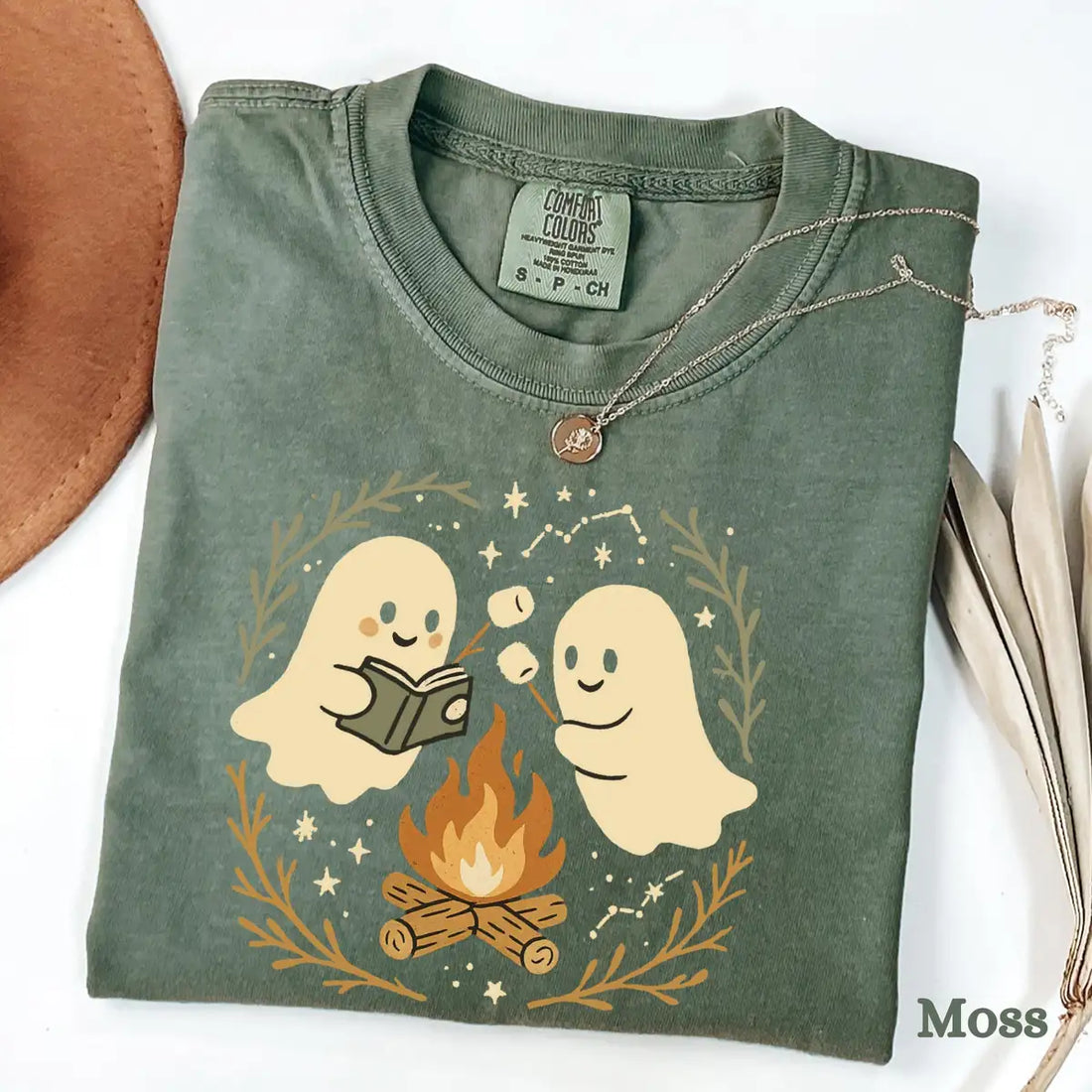 Black Comfort Colors T-shirt mockup showing Retro Ghost Reading Books Halloween design