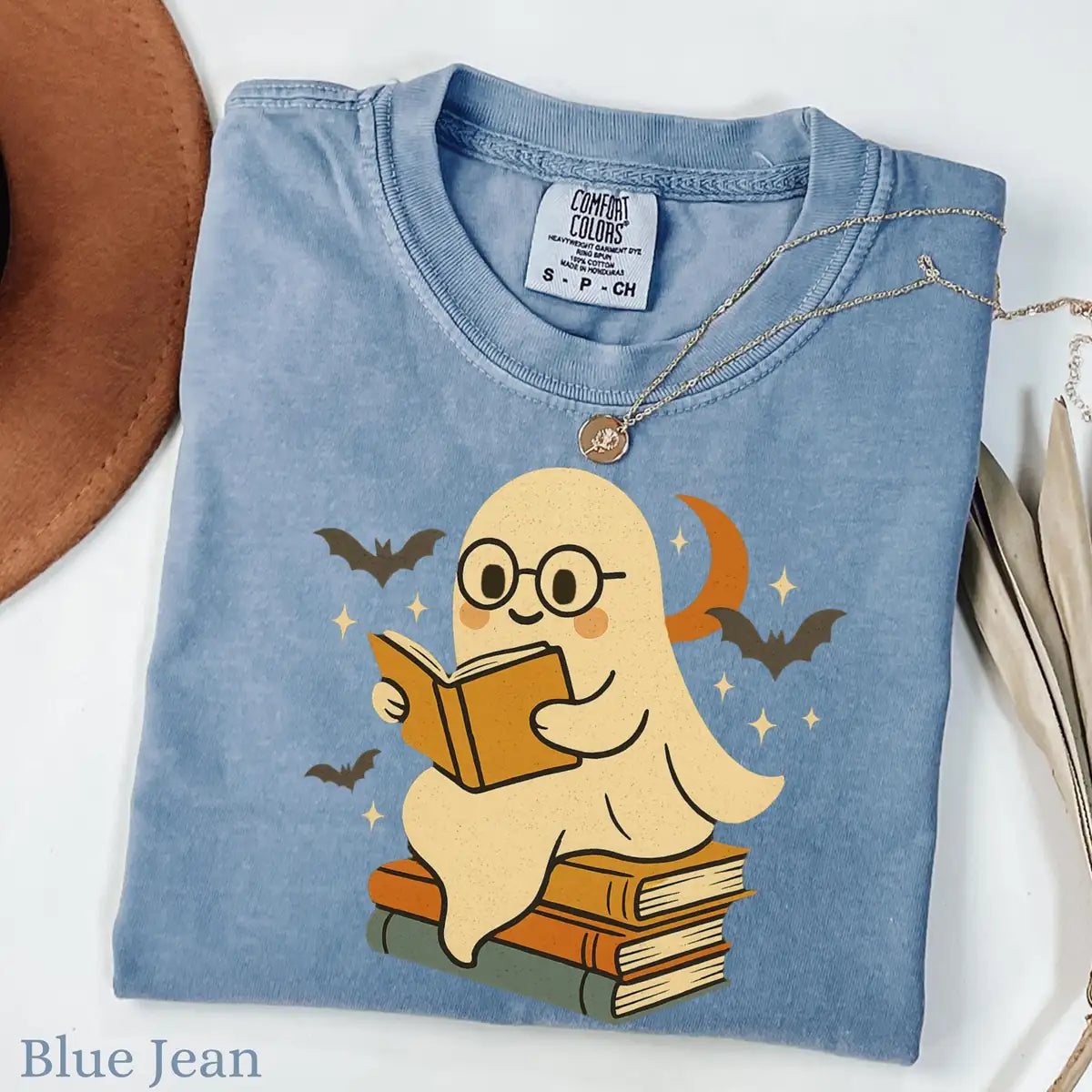 Comfort Colors T-shirt mockup showing Retro Ghost Reading Books Halloween design
