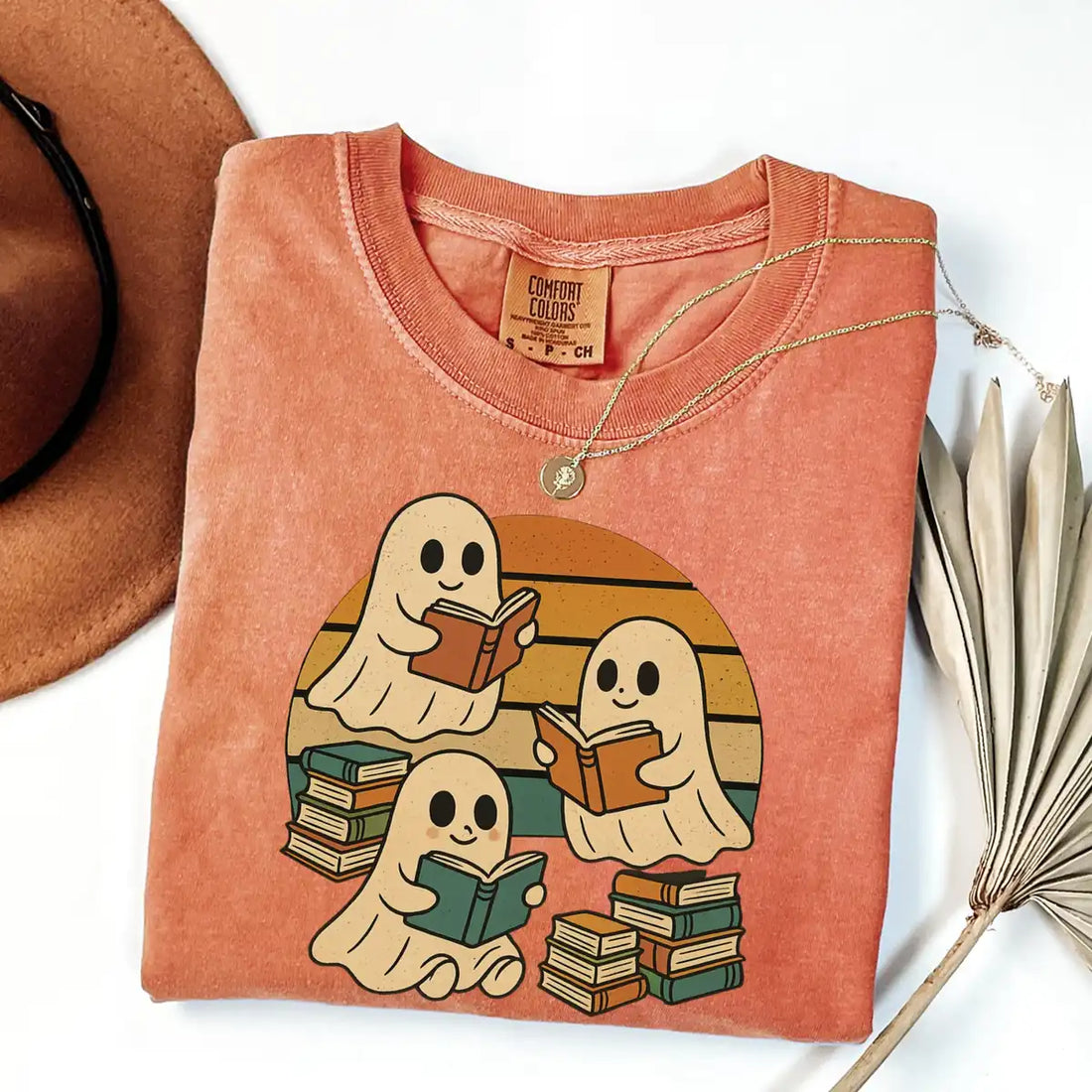 Black Comfort Colors T-shirt mockup showing Retro Ghost Reading Books Halloween design