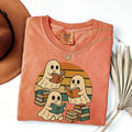 Black Comfort Colors T-shirt mockup showing Retro Ghost Reading Books Halloween design