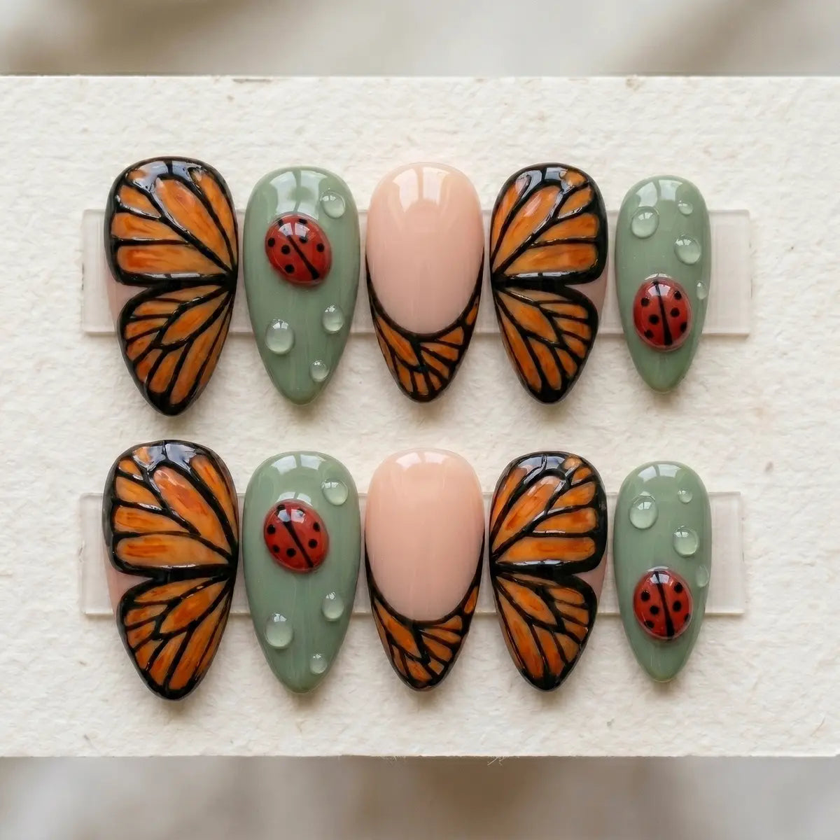 sage green 3d hand painted almond press on nails monarch butterfly water drop mockup 01