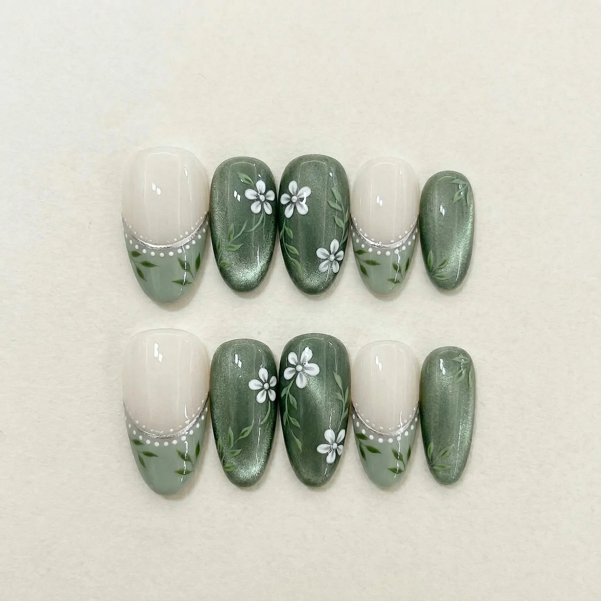sage green cat eye hand painted almond medium press on nails white jasmine flat lay 01