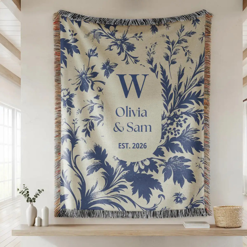 Close-up of the personalized scenic toile woven blanket with monogram and fringe detail