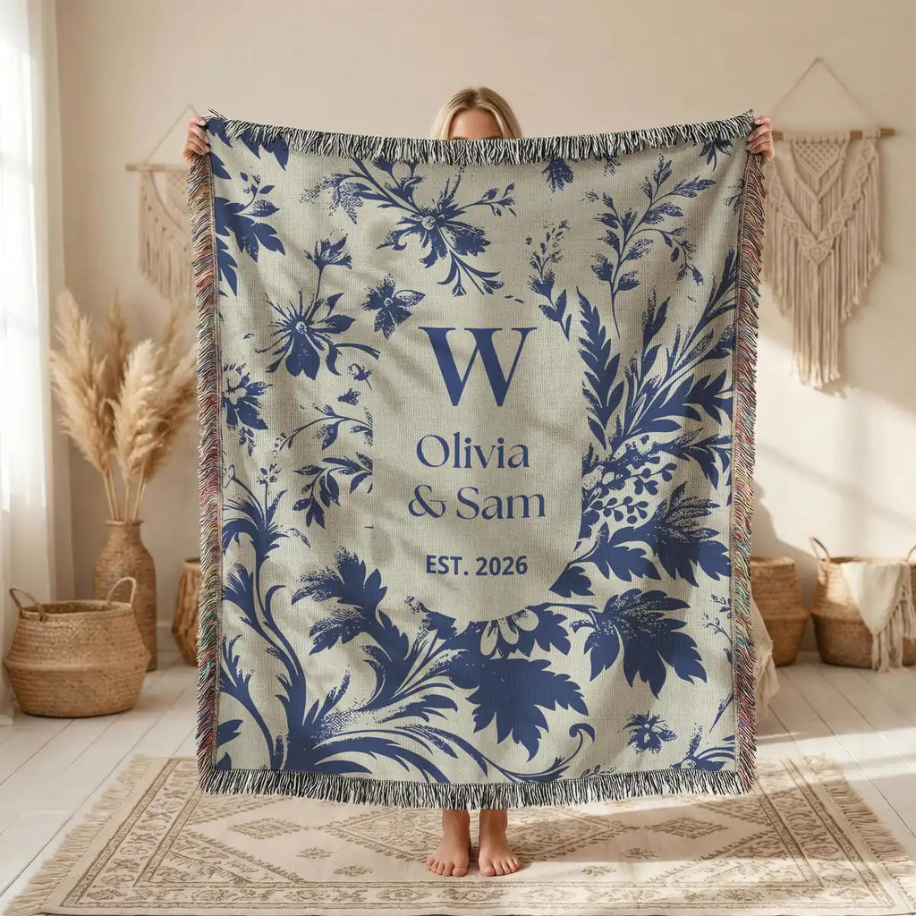 Close-up of the personalized scenic toile woven blanket with monogram and fringe detail