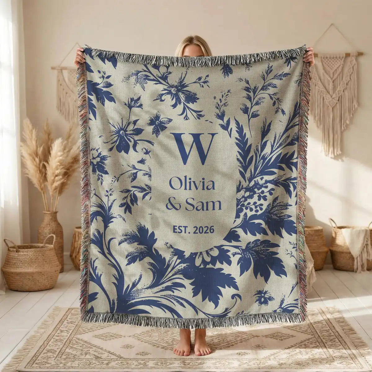 Close-up of the personalized scenic toile woven blanket with monogram and fringe detail
