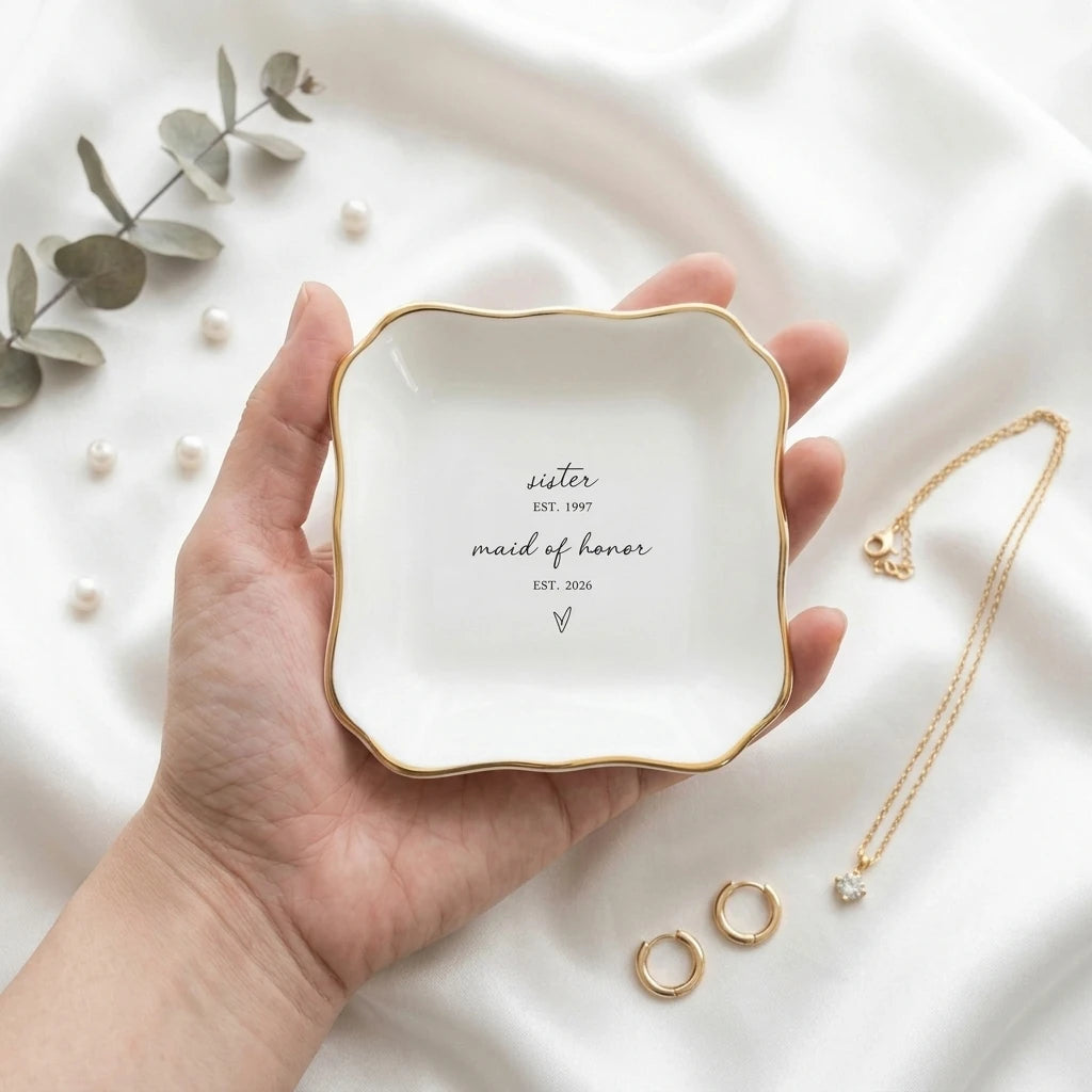 Personalized maid of honor ring dish styled with pearl jewelry on marble