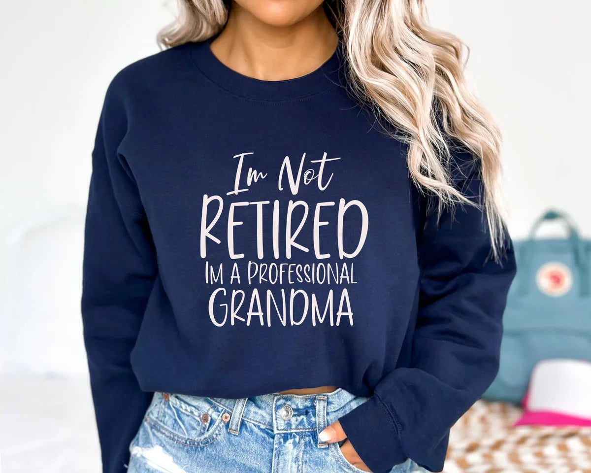 Navy Crewneck sweatshirt with I'm Not Retired I'm A Professional Grandma design, alternate product view.