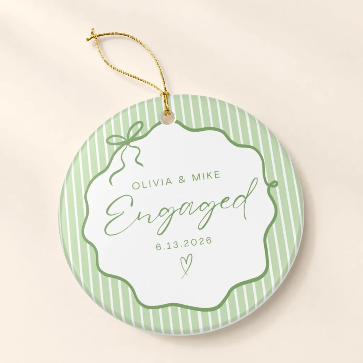 Green pinstripe round ceramic Engaged ornament with a bow frame, personalized names and date, and a gold hanging string