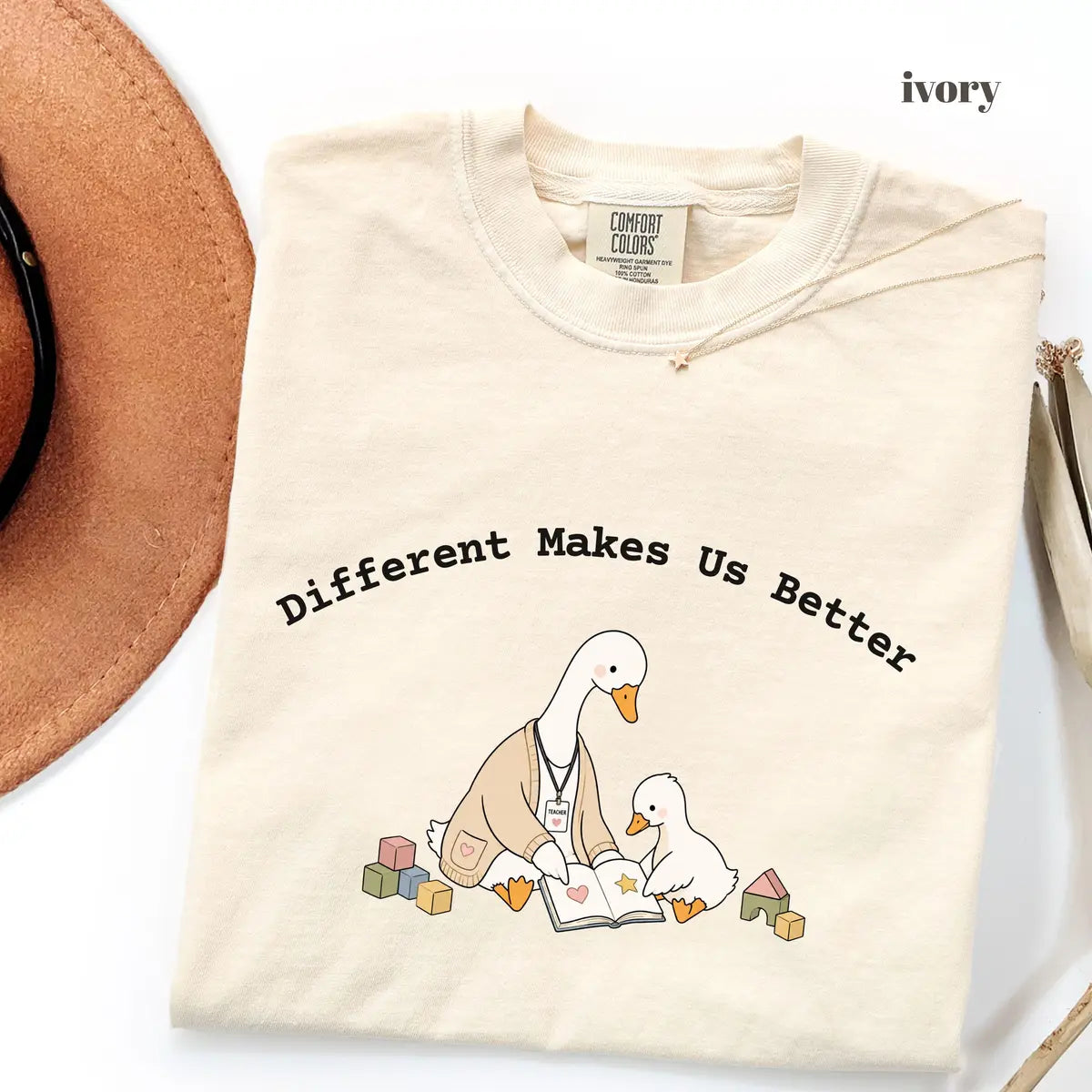 Ivory Comfort Colors 1717 T-shirt with Different Makes Us Better design worn by a model