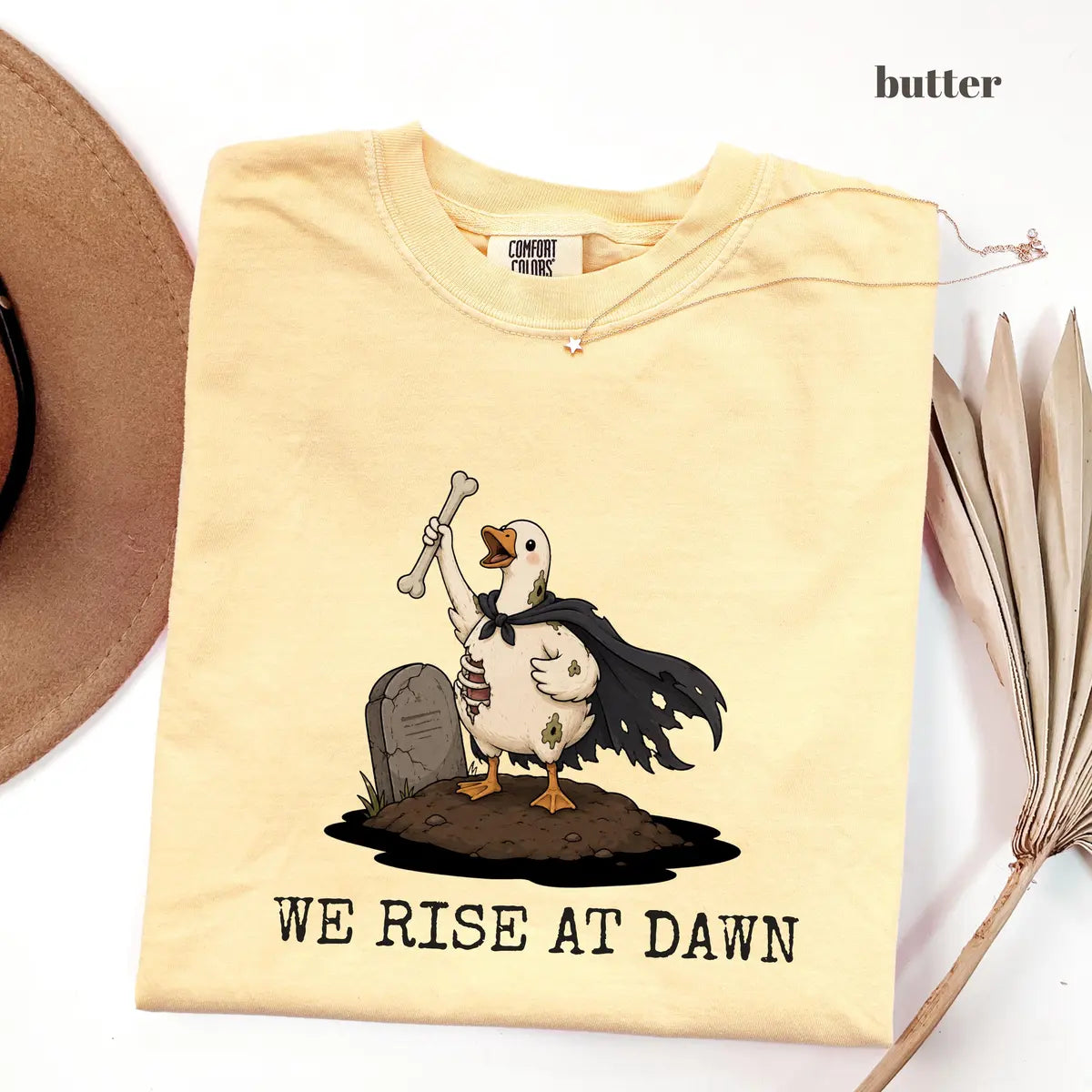 Butter Comfort Colors 1717 T-shirt with We Rise at Dawn Halloween design worn by a model