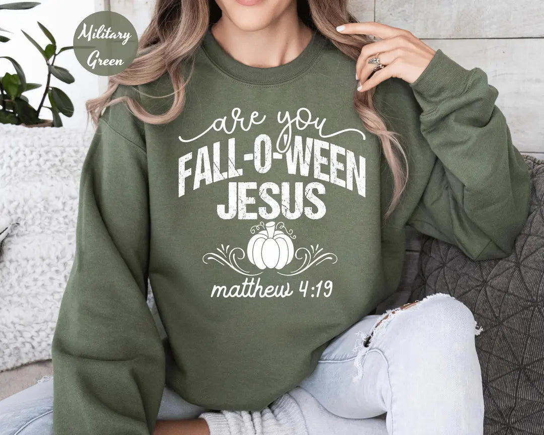Military Green crewneck sweatshirt with printed a pumpkin with the words are you fall-o-ween jesus and matthew 4:19, worn by a model.