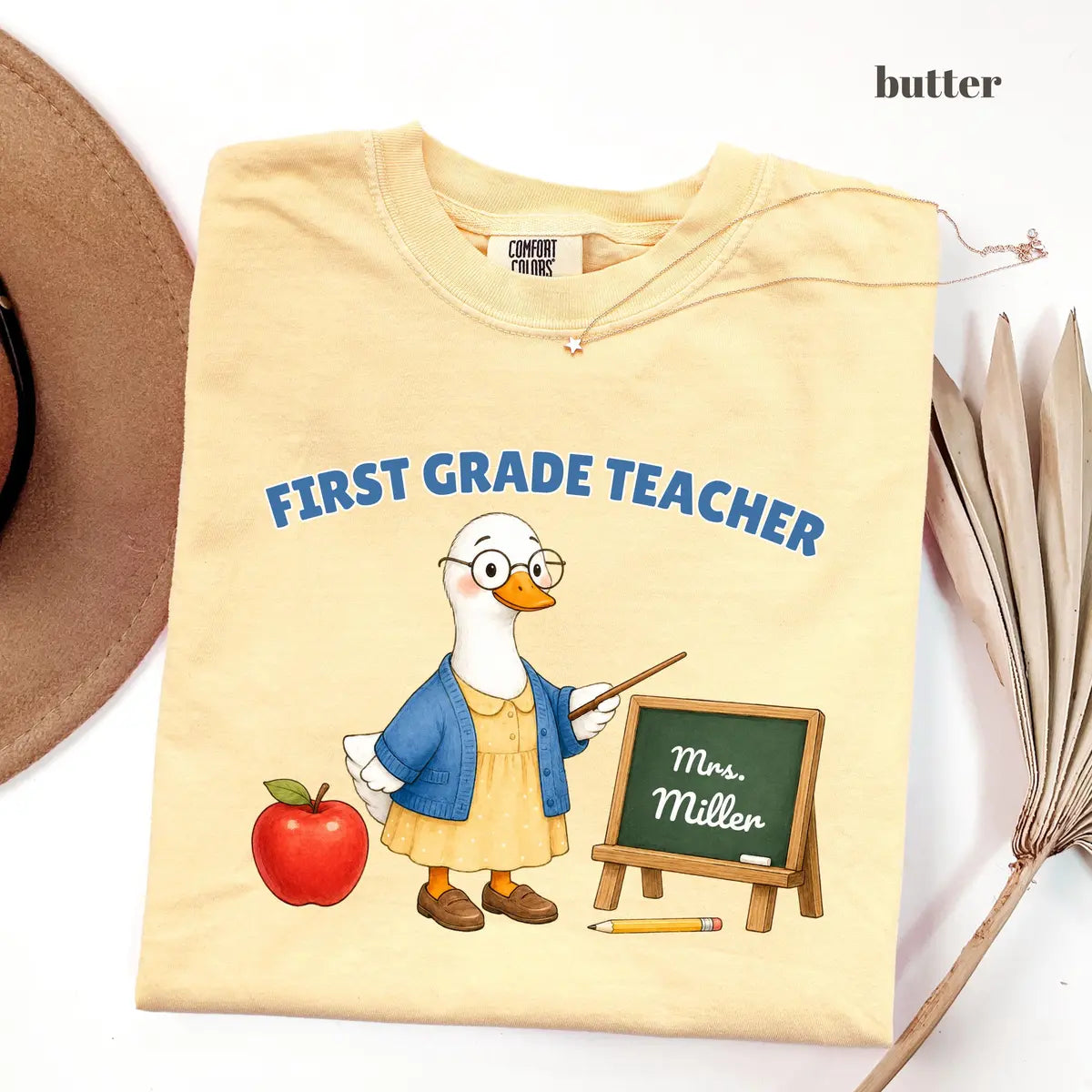 Butter Comfort Colors 1717 T-shirt with First Grade Teacher design worn by a model